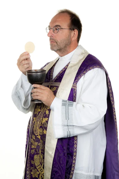 Catholic priest, with chalice and host in communication — Stock Photo, Image