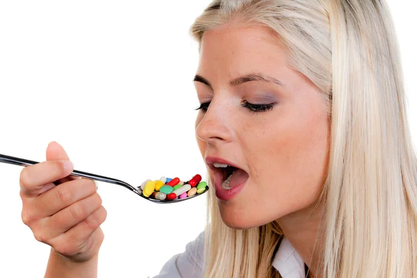 Woman with a lot of pills on spoon Royalty Free Stock Photos