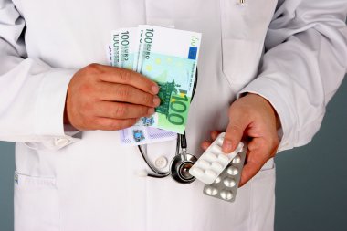 A doctor with dollar bills and pills clipart