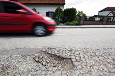 Road with potholes. frost heave clipart