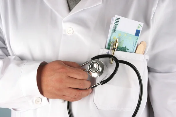 stock image A doctor with dollar bills