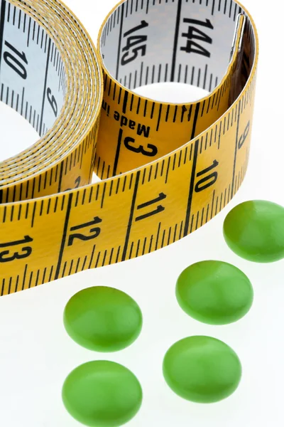 Tape measure and tablets — Stock Photo, Image