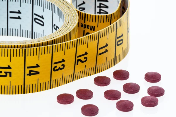 Ruban à mesurer et comprimés — Photo