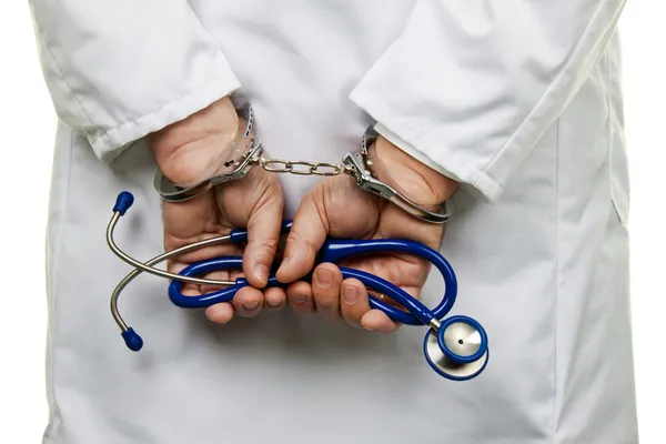 Doctor with handcuffs — Stock Photo, Image