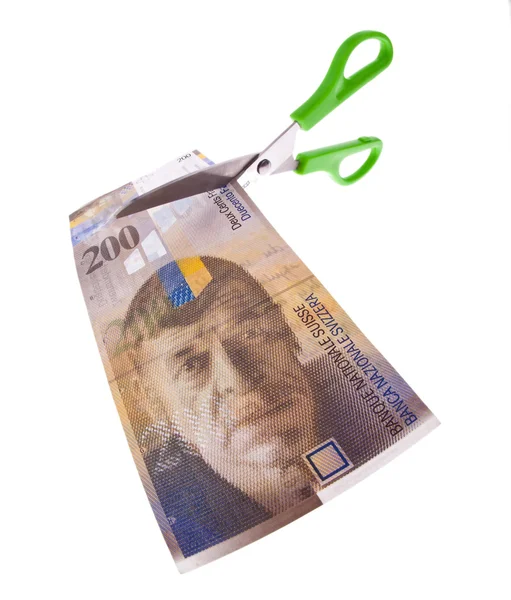 Швейцарский франк и ножницы — стоковое фото