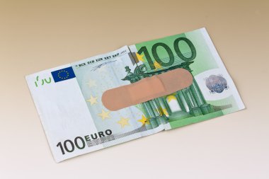 Euro bank notes with adhesive plaster clipart