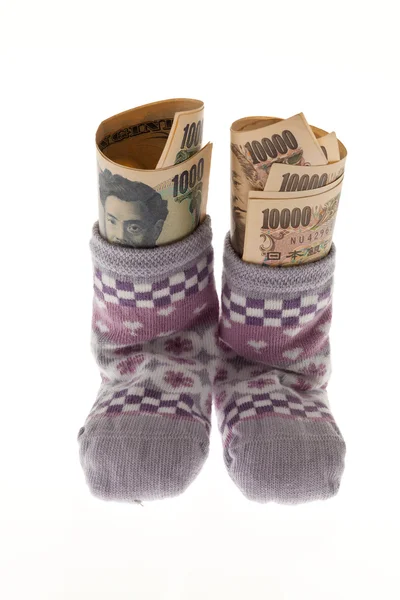 Baby socks on clothesline with yen — Stock Photo, Image