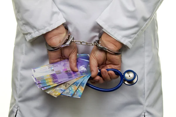 Handcuffs and swiss francs — Stock Photo, Image