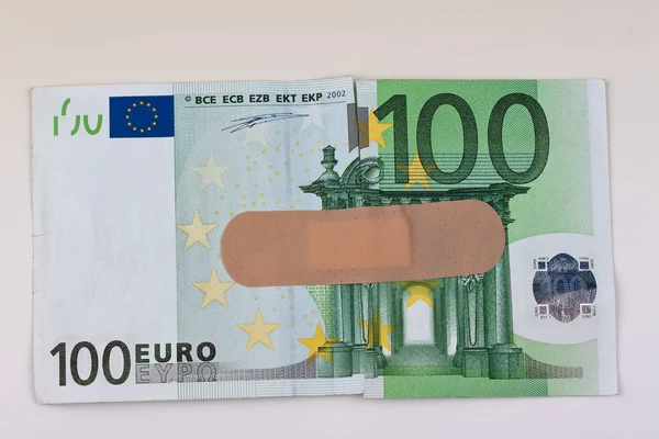 Euro bankovky s náplastí — Stock fotografie