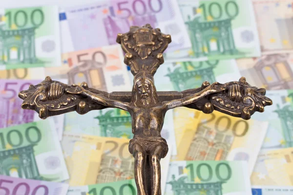 Billets en euros et croix monétaire — Photo