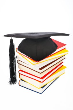 Mortarboard on a book stack clipart