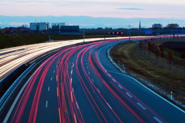 Cars on highway at night clipart