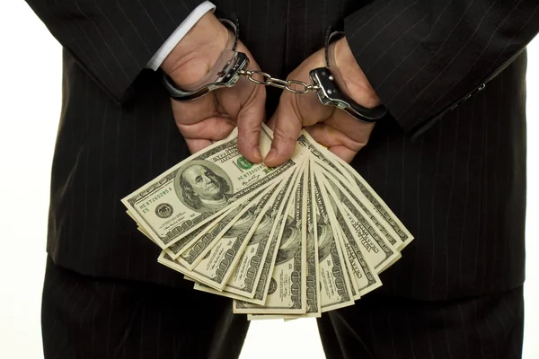 Dollar bills and handcuffs — Stock Photo, Image