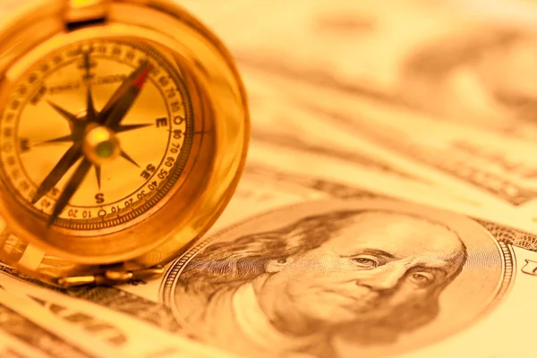 Dollar currency notes and compass — Stockfoto