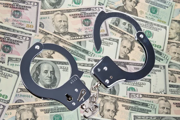 Dollar bills and handcuffs — Stock Photo, Image