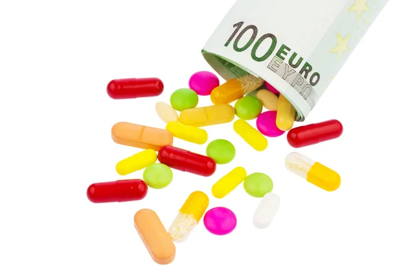 Таблетки и банкнота 100 евро — стоковое фото
