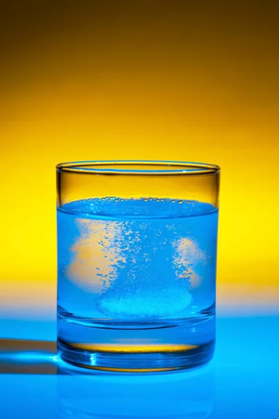 stock image Tablet dissolves in water on glass