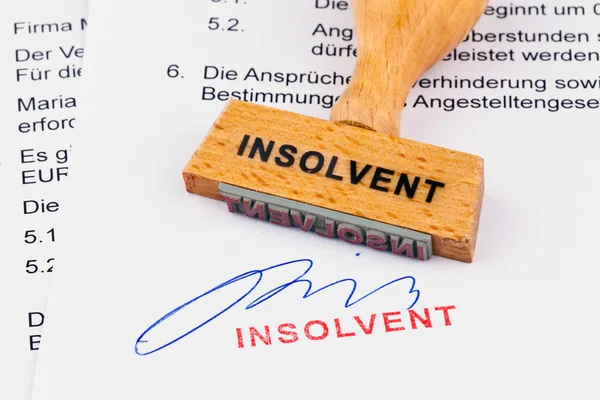 Wooden stamp on the document: insolvent — Stock Photo, Image