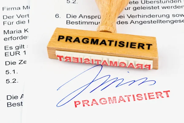 Wooden stamp on the document: pragmatized — Stock Photo, Image