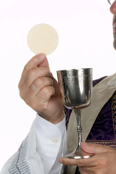 Catholic priest with a chalice and paten — Stock Photo, Image