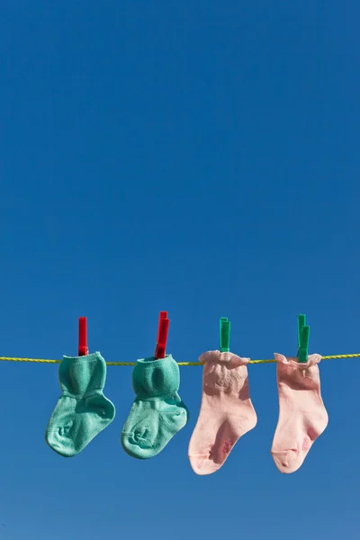 Baby socks on clothesline to dry — Stock Photo, Image
