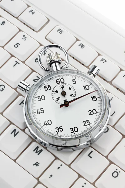 Stock image Clock on computer keyboard