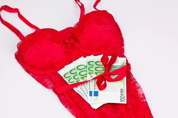 Red lingerie with bills — Stock Photo, Image
