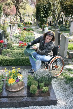 Handicapped woman at the cemetery clipart