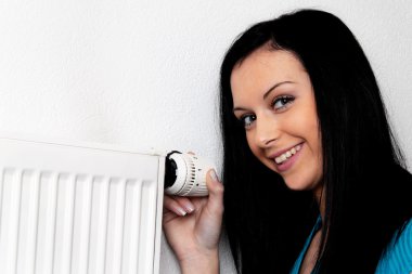 Woman with a heater and thermostat clipart