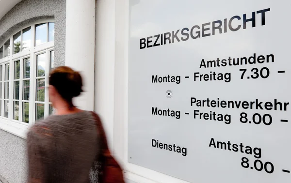 Woman in front of a closed office — Stock Photo, Image