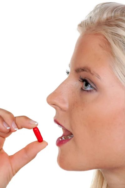 Mulher com um monte de comprimidos na colher — Fotografia de Stock