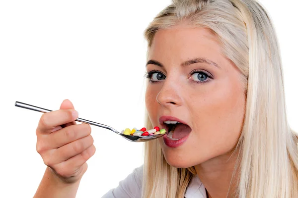 Woman with a lot of pills on spoon — Stock Photo, Image