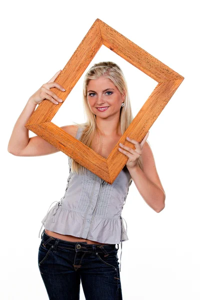 Woman looking through a picture frame — Stock Photo, Image
