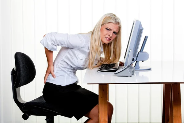 Woman with pain in the back office — Stock Photo, Image