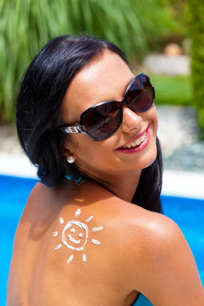 プールで日焼け止めを持つ女性 — ストック写真