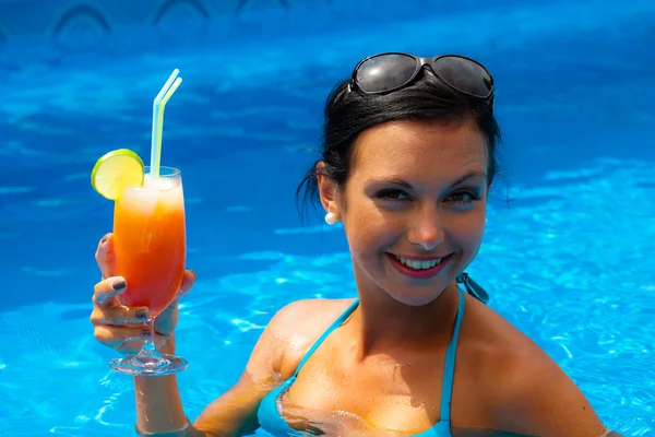 Woman with cocktail in the pool — Stock Photo, Image