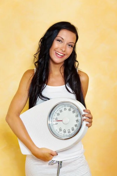 Woman with scales after a successful diet — Stock Photo, Image