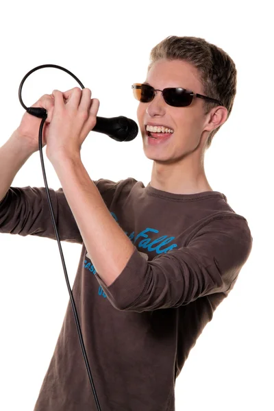 Young singer with a microphone during a performance — Stock Photo, Image