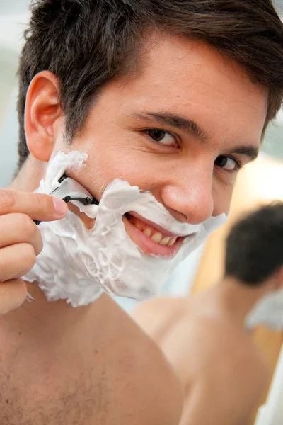stock image Man shaves with a razor blade