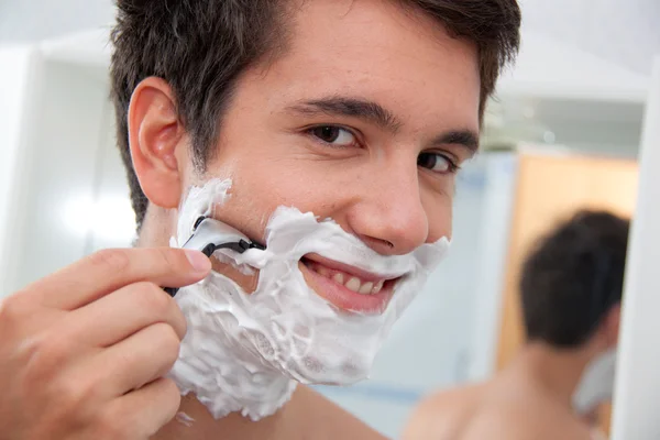 stock image Man shaves with a razor blade