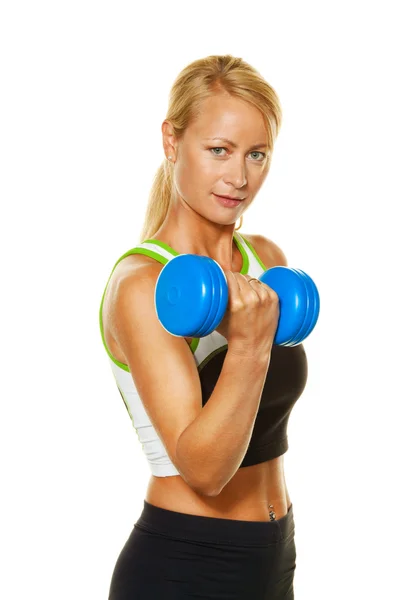 Woman with dumbbells when training for strength and fitness faci — Stock Photo, Image