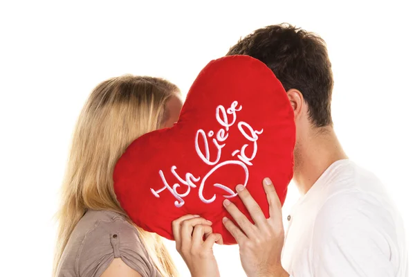 Couple in love kissing behind a heart. — Stock Photo, Image