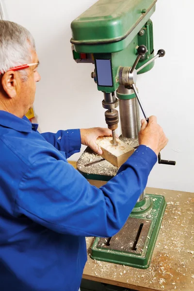 Carpenter at a drill — Stock Photo, Image