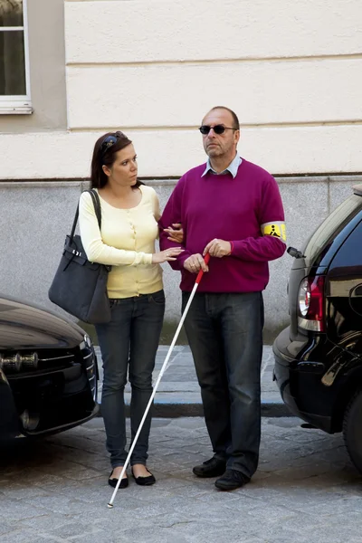 Woman helps blind man — Stok fotoğraf