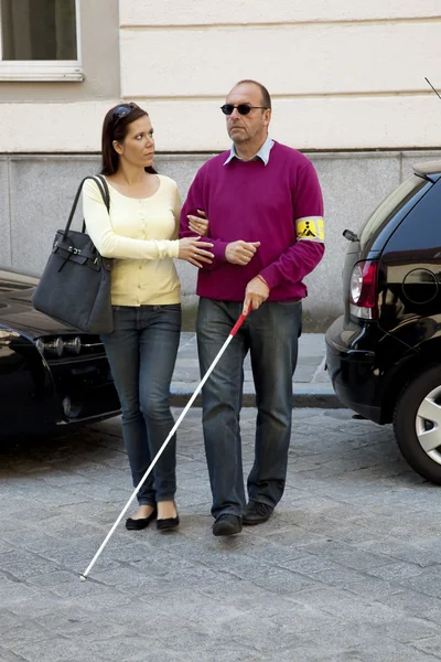 Woman helps blind man — Stok fotoğraf