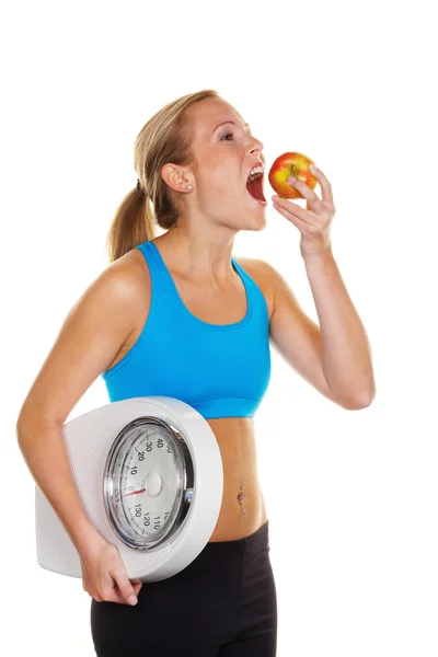 Woman with bathroom scale and apple — Stock Photo, Image