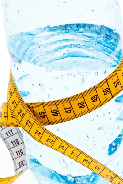 stock image Mineral water with measuring tape. symbol for diet.