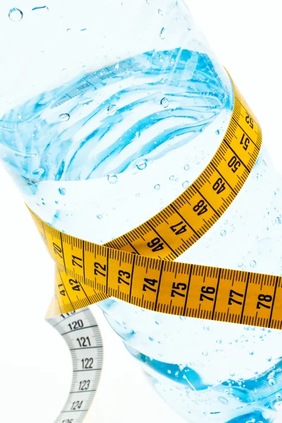 Mineral water with measuring tape. symbol for diet. — Stock Photo, Image