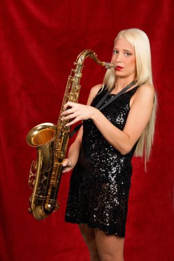 Young pretty woman playing saxophone clipart