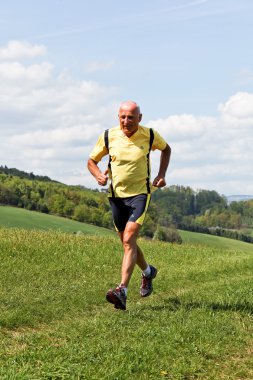 Senior running when jogging in the winter clipart